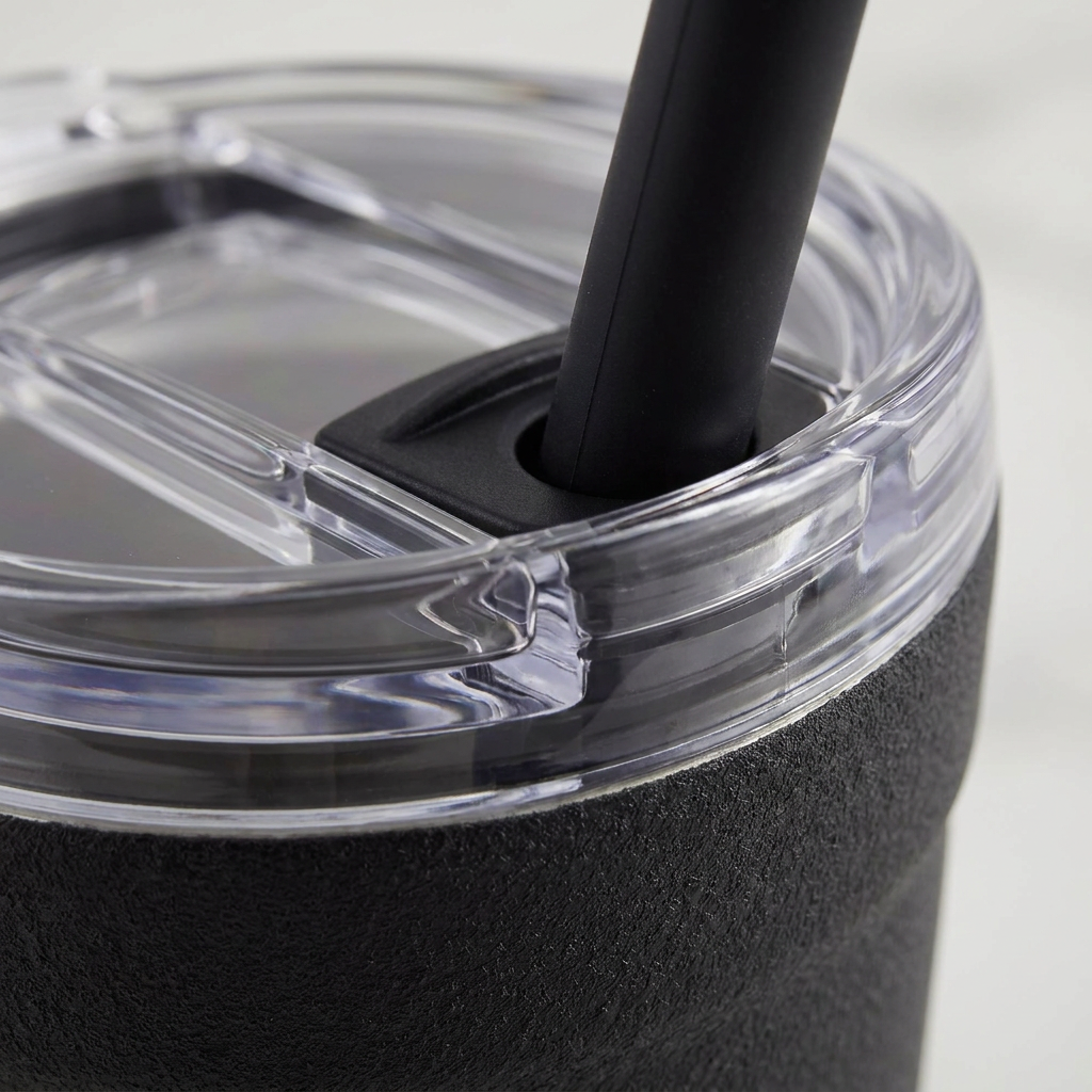 An extreme close-up of the clear lid and black straw seal on the bubba Envy S tumbler, highlighting its secure fit.