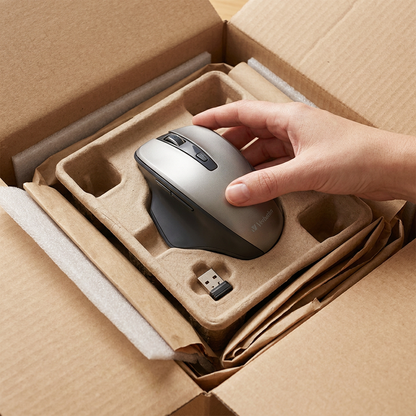 Verbatim Silent Ergo Wireless Mouse being unboxed from a protective cardboard and molded pulp tray with USB receiver.