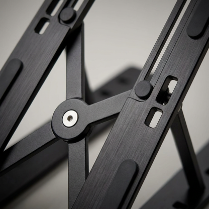 An extreme close-up view of the central hinge and adjustment slots of the black metal Kensington laptop riser, highlighting its sturdy construction and precise mechanism.