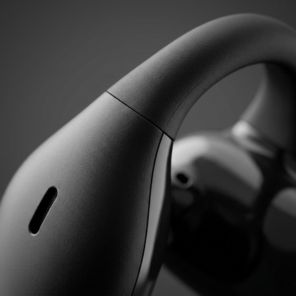 A macro shot highlighting the precise seam and fine matte texture on the earclip joint of the SHARP HP-TW45-BK earbuds.
