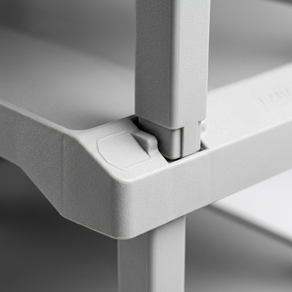 A close-up photograph of the interlocking stackable connector on the light grey plastic RAKABOT Plastico shoe rack.