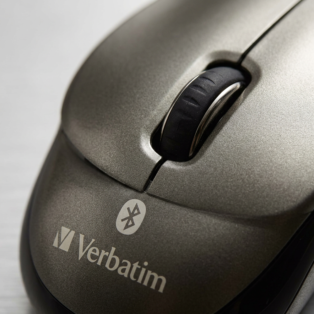 Macro photo detailing the scroll wheel and 'Verbatim' logo on a graphite Bluetooth mouse surface.