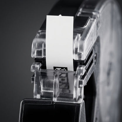 An extreme close-up view focusing on the clear label cassette tip, showing the precise path for the white plastic tape, the black printing mechanism section, and the complex injection-molded internal guide pins and texture of the robust black plastic body.