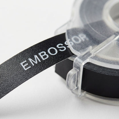 Extreme close-up of the black embossing tape and the plastic shell, showing material textures.