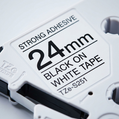 Macro detail of Brother TZe-S251 label cassette housing showing 24mm strong adhesive markings.