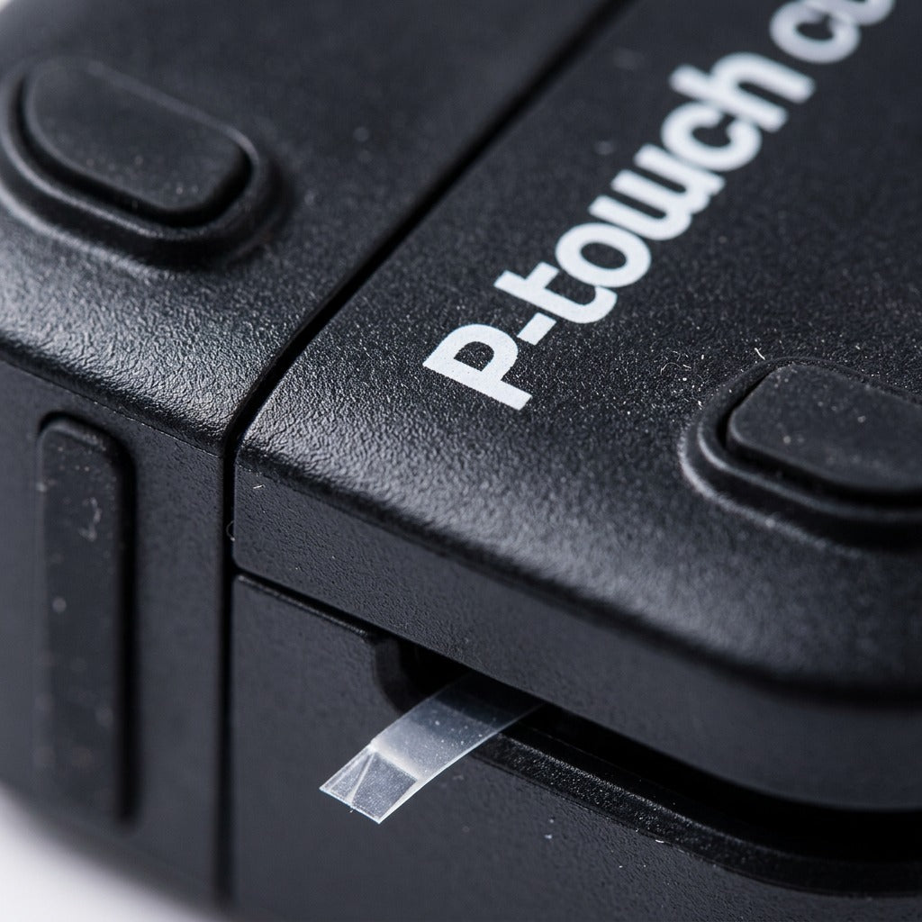 Macro detail of the Brother PT-P710BT showing the matte black texture and clear label tape exit.